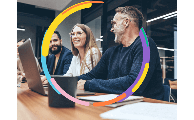 Foto de dos hombres y una mujer sonriendo entre ellos, mientas tienen sus computadores portátiles para hacer la vinculación a Leasing Bancolombia.